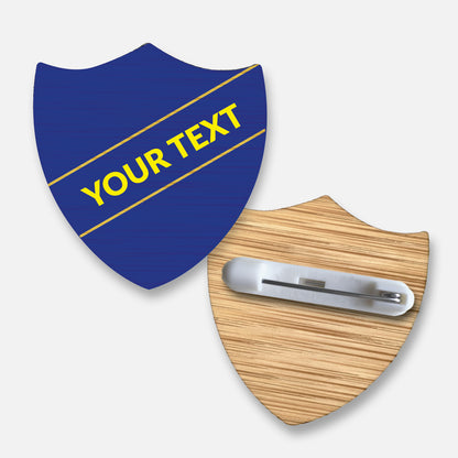 Personalised bamboo shield-shaped badge with a choice of 17 background colours.  Features a diagonal single line of customisable text in your choice of font and colour; measures approximately 34mm x 36mm and includes a pin fastening on the reverse.