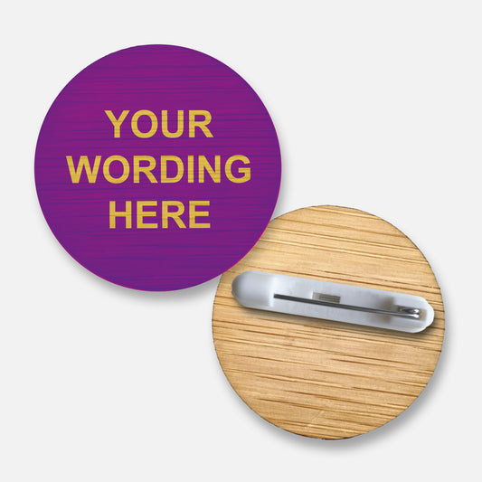 A 38mm circular badge crafted from natural bamboo, featuring the placeholder text 'Your Wording Here' in green capital letters on the front, with a pin fastening on the reverse side.