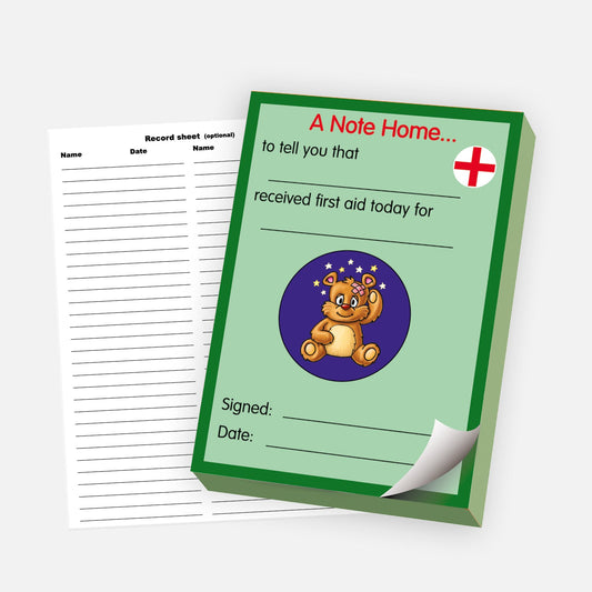 'A Note Home' first aid pad with a green background, featuring a red cross and a cartoon teddy bear with a bandage. The note reads 'to tell you that [blank] received first aid today for [blank],' with additional spaces for a signature and date. A detachable record sheet for logging entries is shown beside the pad.