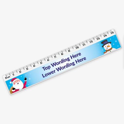 15cm plastic ruler with a blue background, featuring cartoon illustrations of Father Christmas and a snowman at each end, and space in the centre for two lines of custom festive wording.