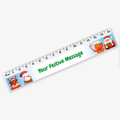 Festive 15cm white plastic ruler featuring cartoon images of a reindeer, snowman, gingerbread figure, and Father Christmas, with a space in the centre for a custom festive message.
