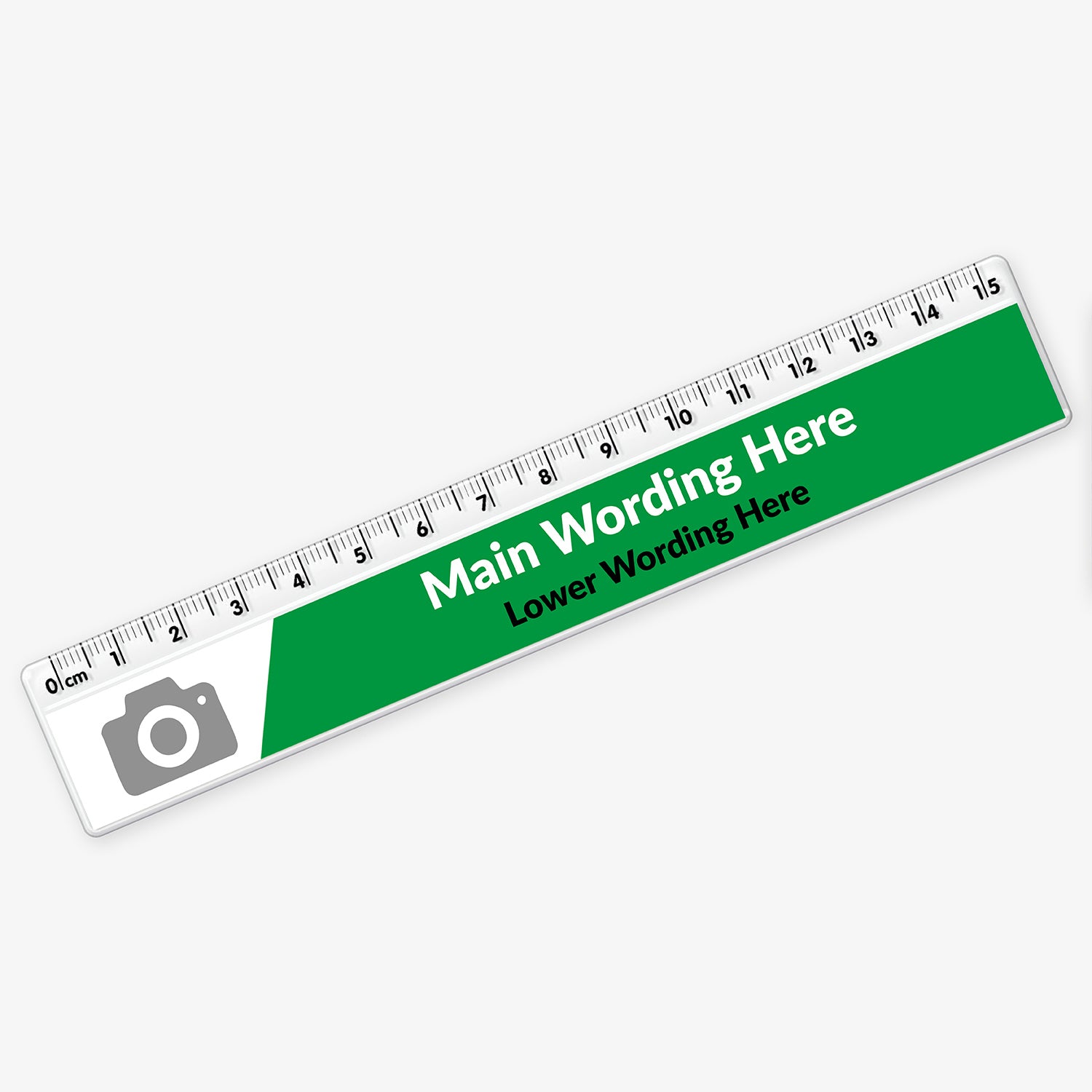 Customisable plastic ruler with a green and white design. It includes placeholder text reading 'Main Wording Here' and 'Lower Wording Here' in bold and regular fonts. A grey camera icon marks the area for a potential logo or image. The ruler is marked with centimetres and millimetres from 0 to 15.