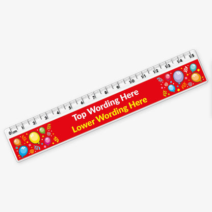 A 15cm plastic ruler with black measurement markings along the top edge. The design features a bright red background with colourful balloons and confetti. In the centre, large white text reads 'Top Wording Here', with yellow placeholder text below saying 'Lower Line Wording Here'.