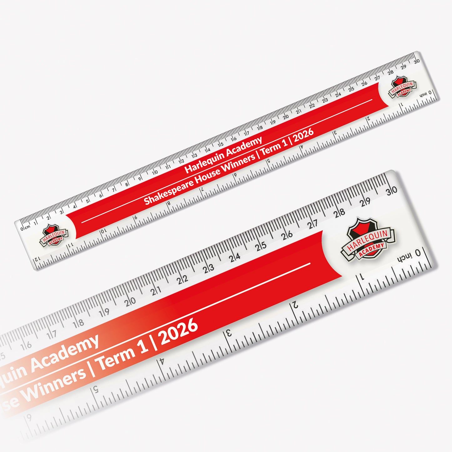 Customisable 30cm plastic ruler with a red background. Includes placeholder text across two lines with camera icons at both ends indicating space for logos or images. The ruler features centimetre and millimetre markings along the top edge and inches on the bottom.