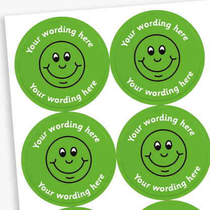 A sheet of green stickers featuring a black outline of a smiling face in the centre.  Placeholder text 'Your wording here' is above and below the image for customisation.