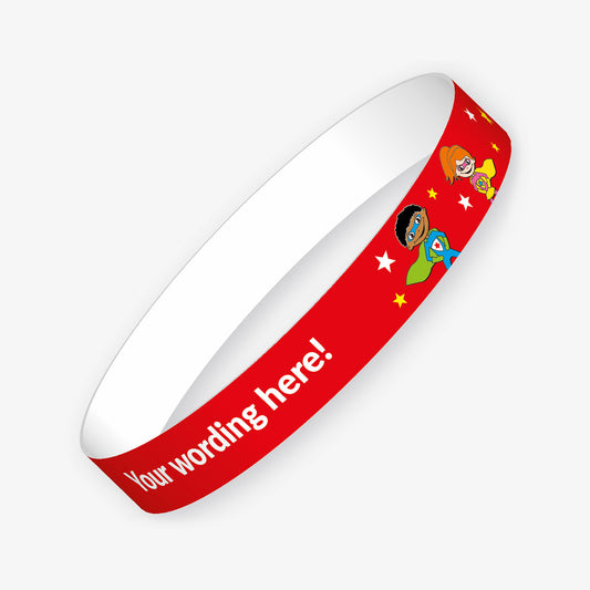 A red customisable wristband with the placeholder text 'Your wording here!' in bold white letters. The design features cheerful cartoon superheroes and scattered yellow and white stars.