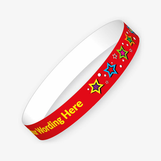 A customisable red wristband featuring the placeholder text 'Your Wording Here' in yellow. The design includes various coloured stars with contracting central colour, surrounded by small decorative dots.