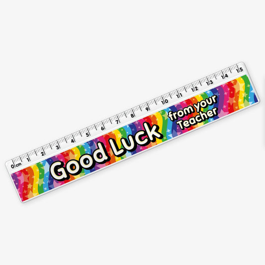 15cm ruler featuring a vibrant rainbow background with stars and bold yellow and white text reading 'Good Luck from your Teacher' along the centre.