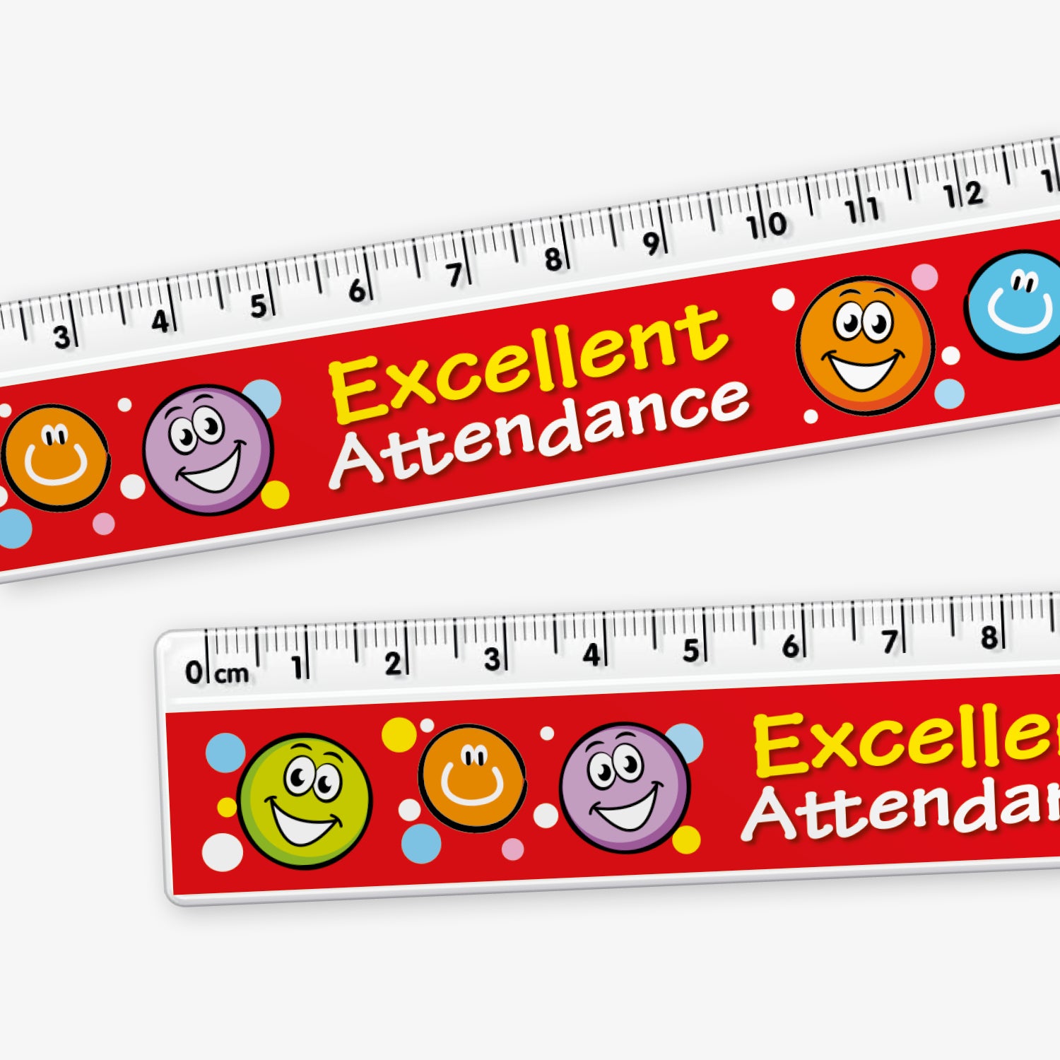 Close up of 15cm ruler with a red background, decorated with colourful smiley face icons and white polka dots. The ruler features the words 'Excellent Attendance' in bold yellow and white text across the middle.