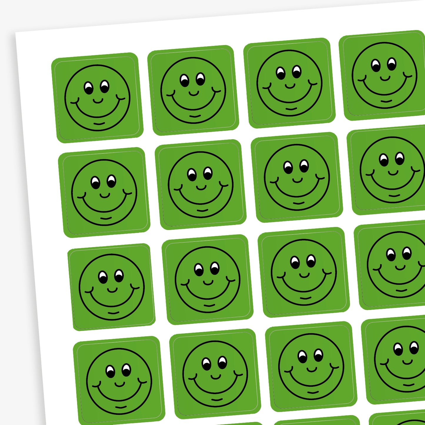 A sheet of 140 square 16mm reward stickers, each featuring a black outline of a smiling comical face, set against a vibrant green background.