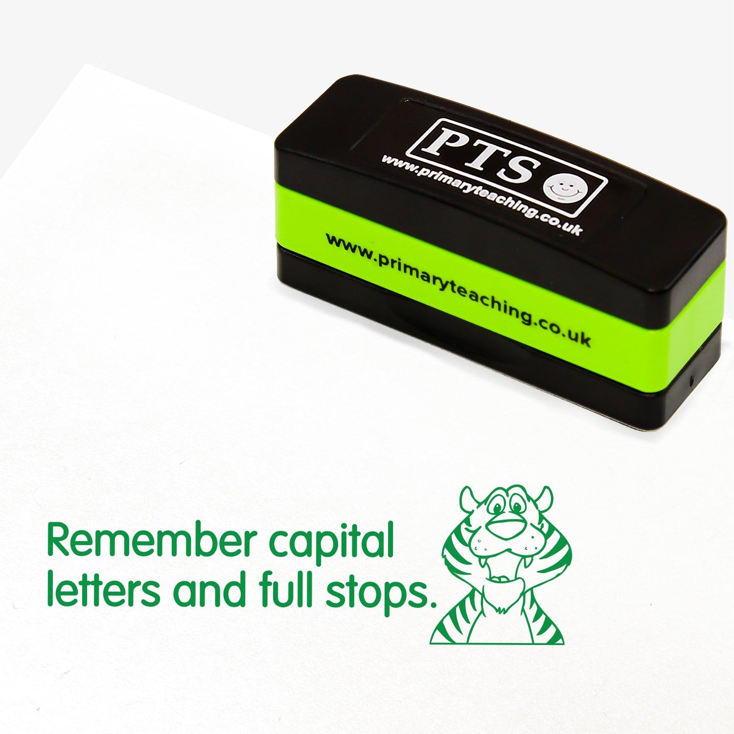 Rectangular self-inking stamper measuring 44mm by 13mm, featuring a green impression of the phrase 'Remember capital letters and full stops.' alongside a smilng tiger.