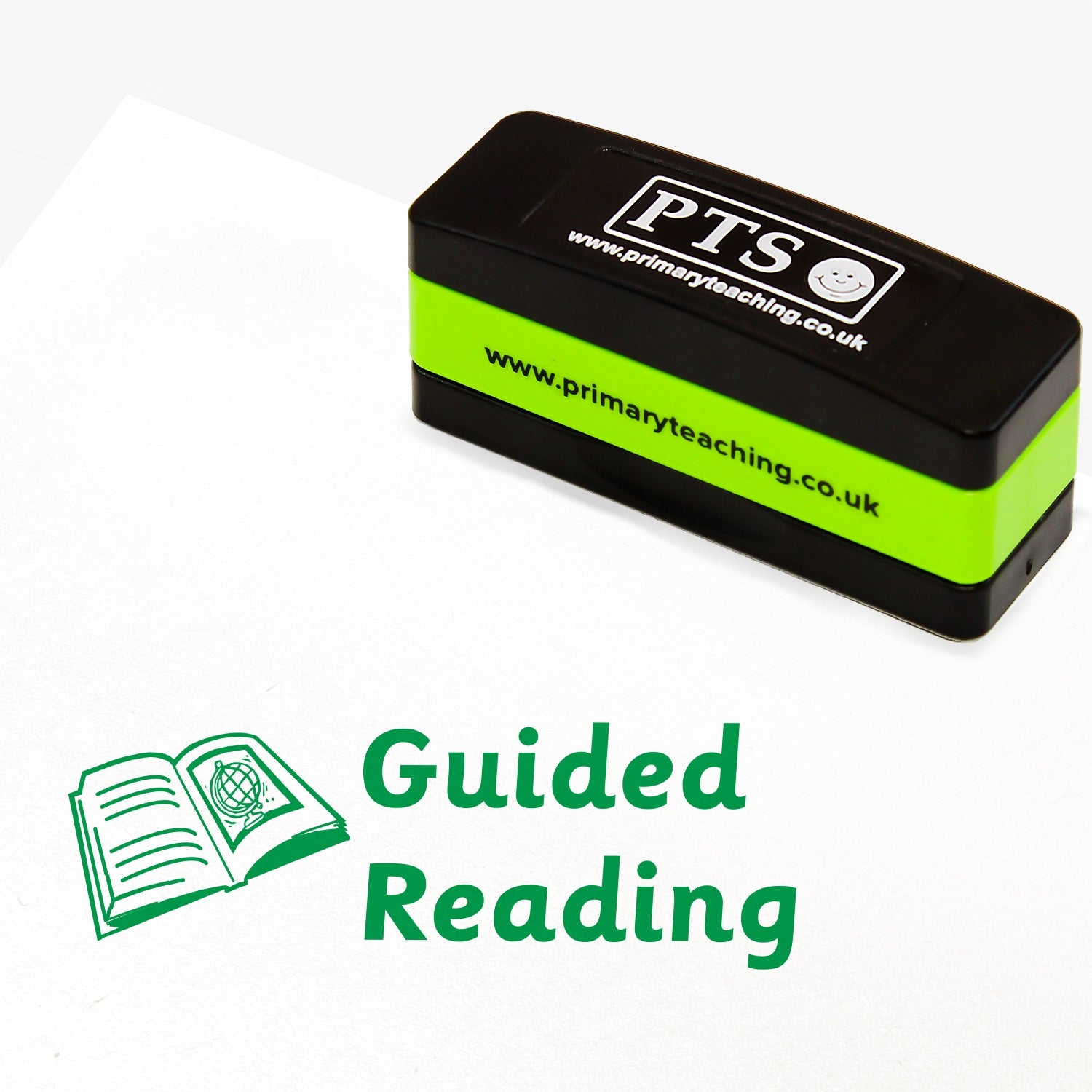 44mm x 13mm self-inking stamper featuring the phrase 'Guided Reading.' in bold green letters next to an illustration of an open book with lines on one page and a globe on the facing page.