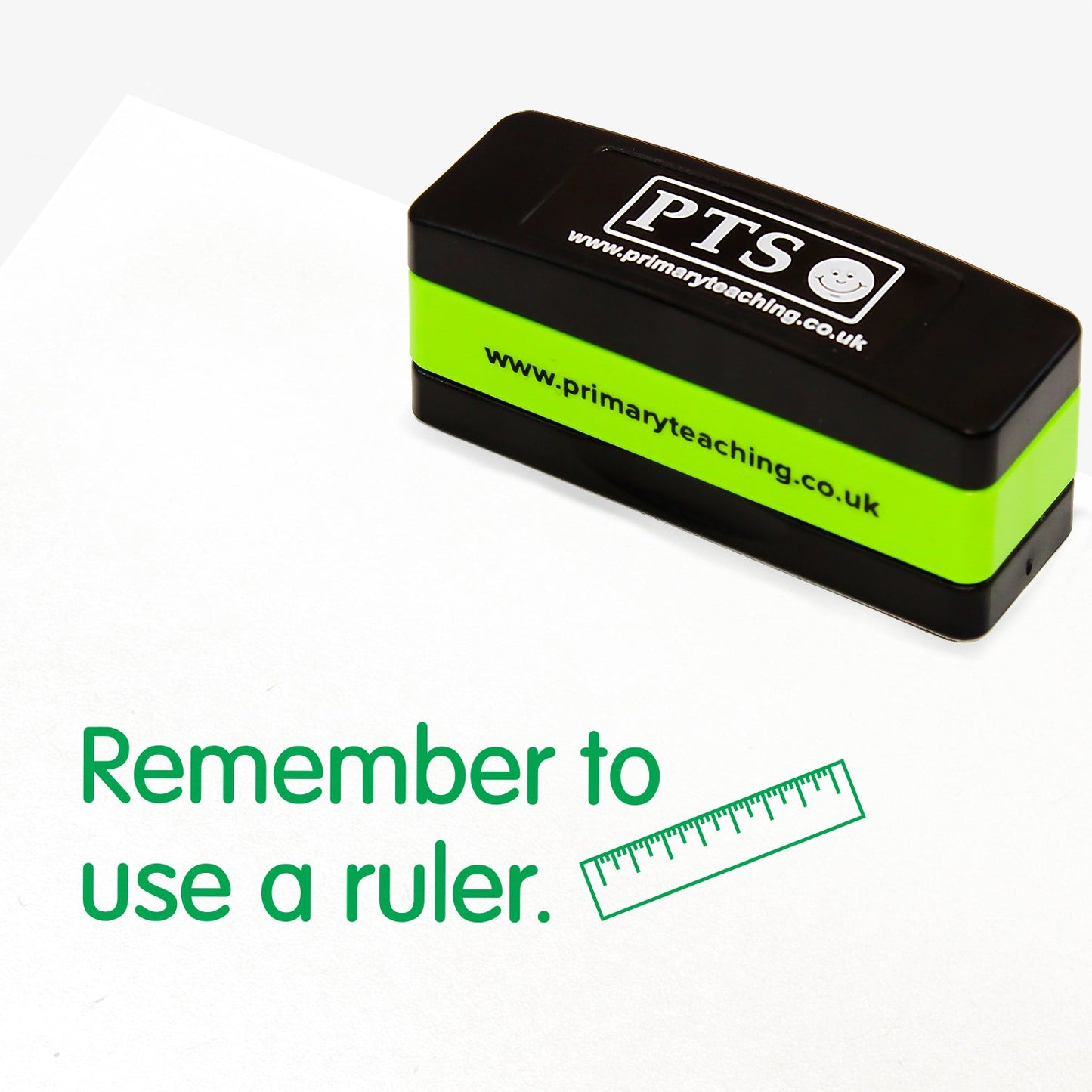 Rectangular self-inking, stackable stamper 44mm x 13mm with green ink, featuring the phrase 'Remember to use a ruler' followed by an illustration of a ruler.