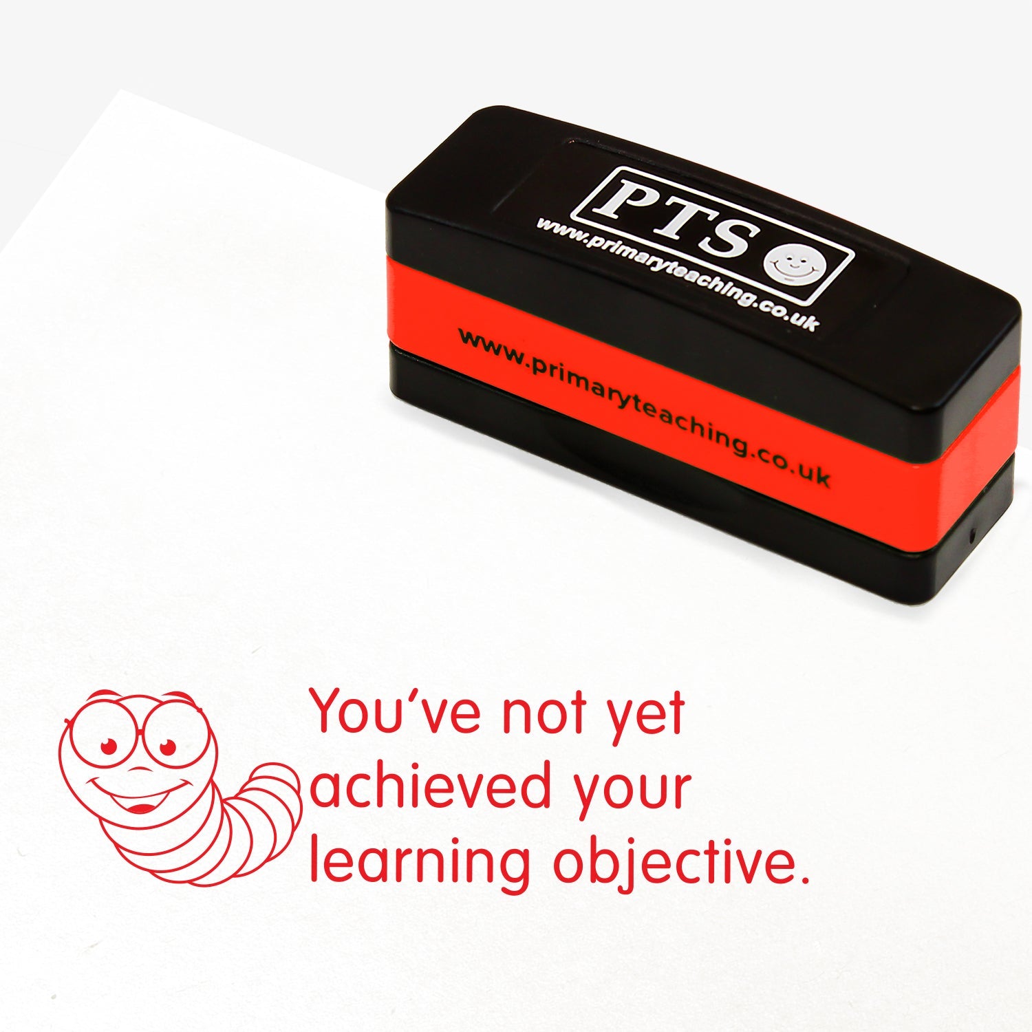 A rectangular, stackable, self-inking stamper, displaying the red text 'You've not yet achieved your learning objective' alongside a smiling bookworm; the stamped impression measures 44mm by 13mm