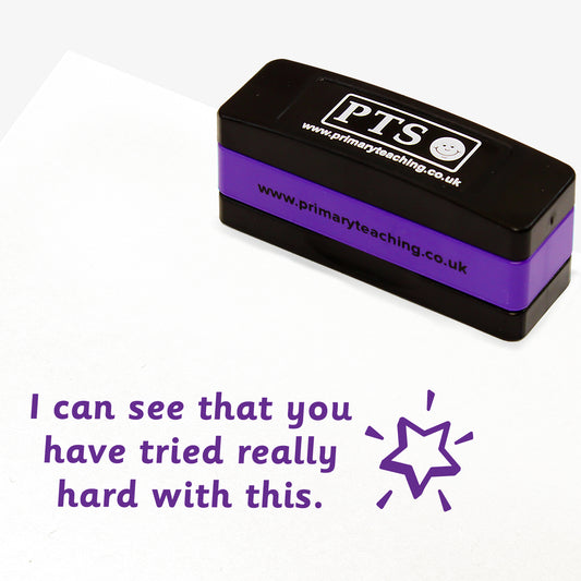Rectangular self-inking, stackable, stamper 44mm x 13mm with purple ink, featuring the phrase 'I can see that you have tried really hard with this.' across 3 lines of text.  Next to the phrase is a shining star icon.