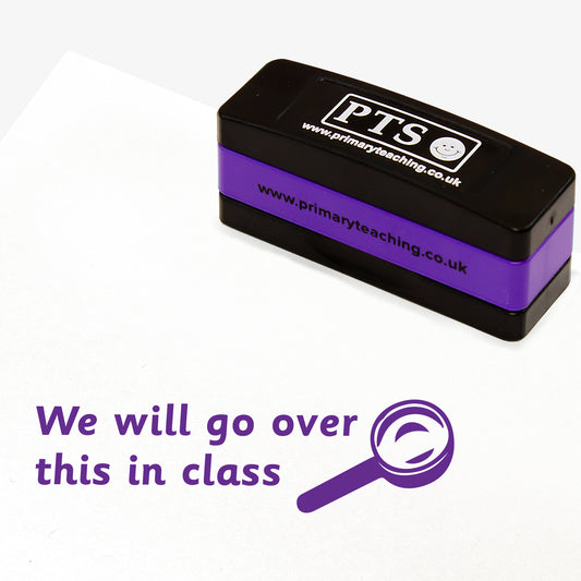 Rectangular self-inking stackable stamper 44mm x 13mm with purple ink, displaying the text 'We will go over this in class' alongside the purple outline of a magnifying glass.