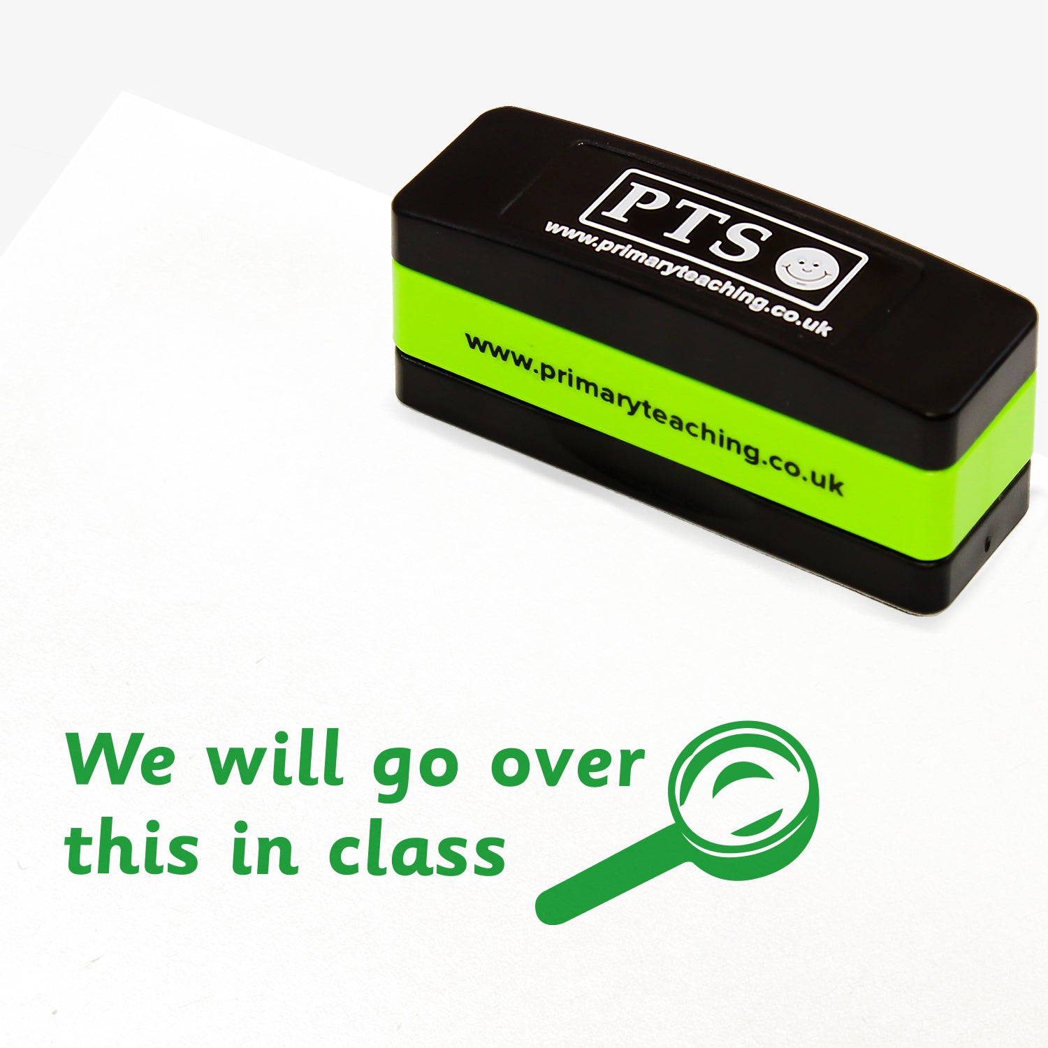 Rectangular self-inking stackable stamper 44mm x 13mm with green ink, displaying the text 'We will go over this in class' alongside the green outline of a magnifying glass.