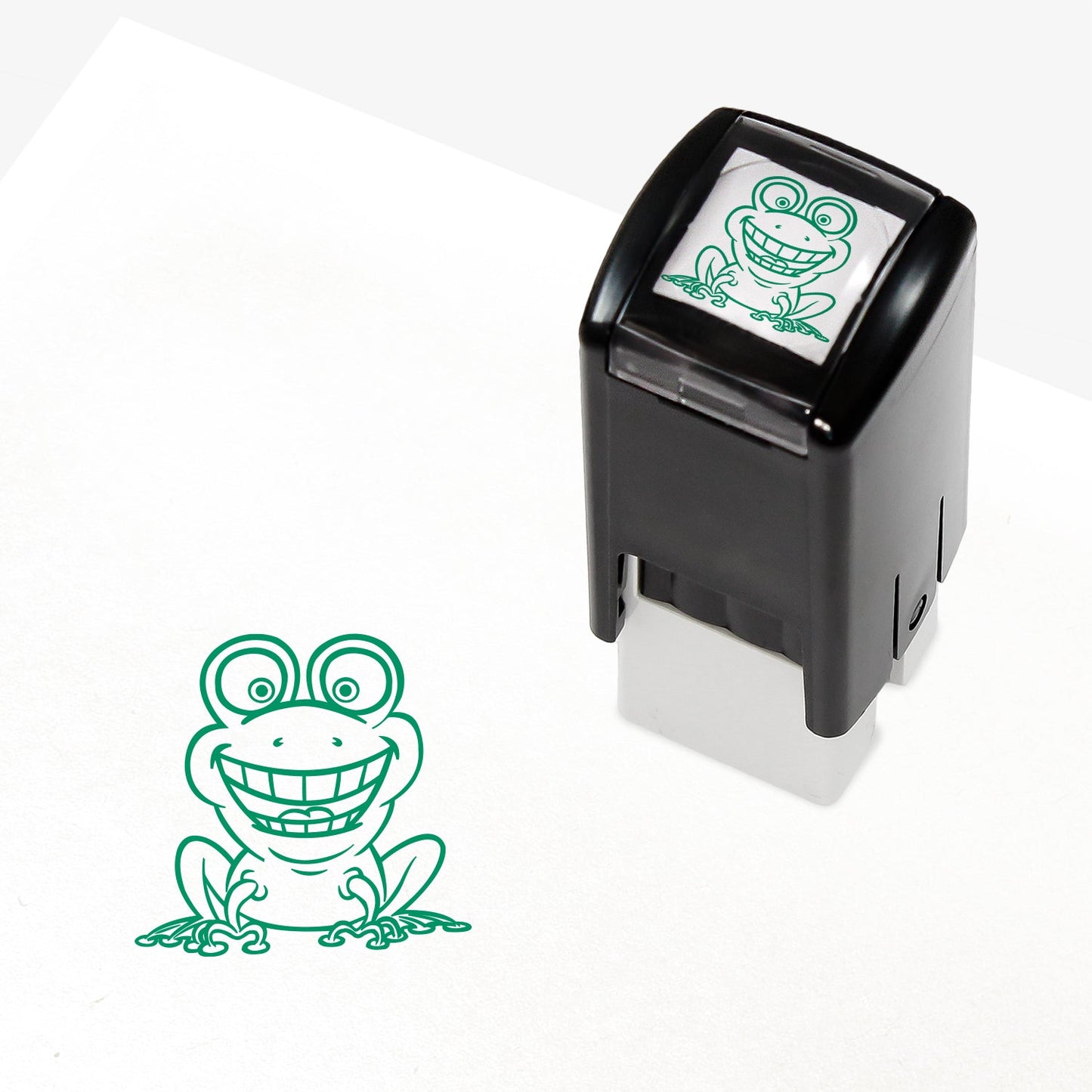 A 10mm self-inking stamp with a green smiling frog central to the design