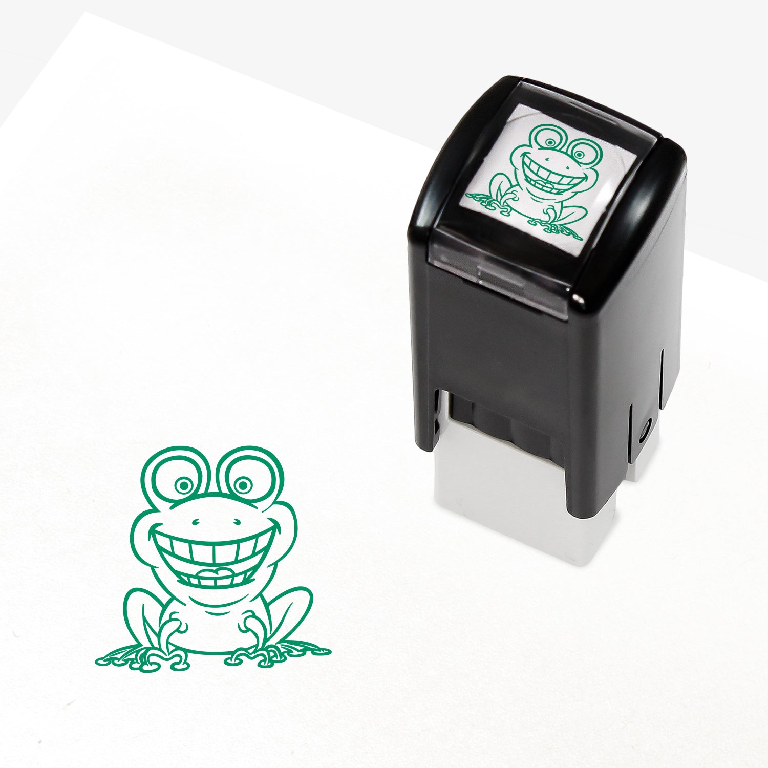 A 10mm self-inking stamp with a green smiling frog central to the design
