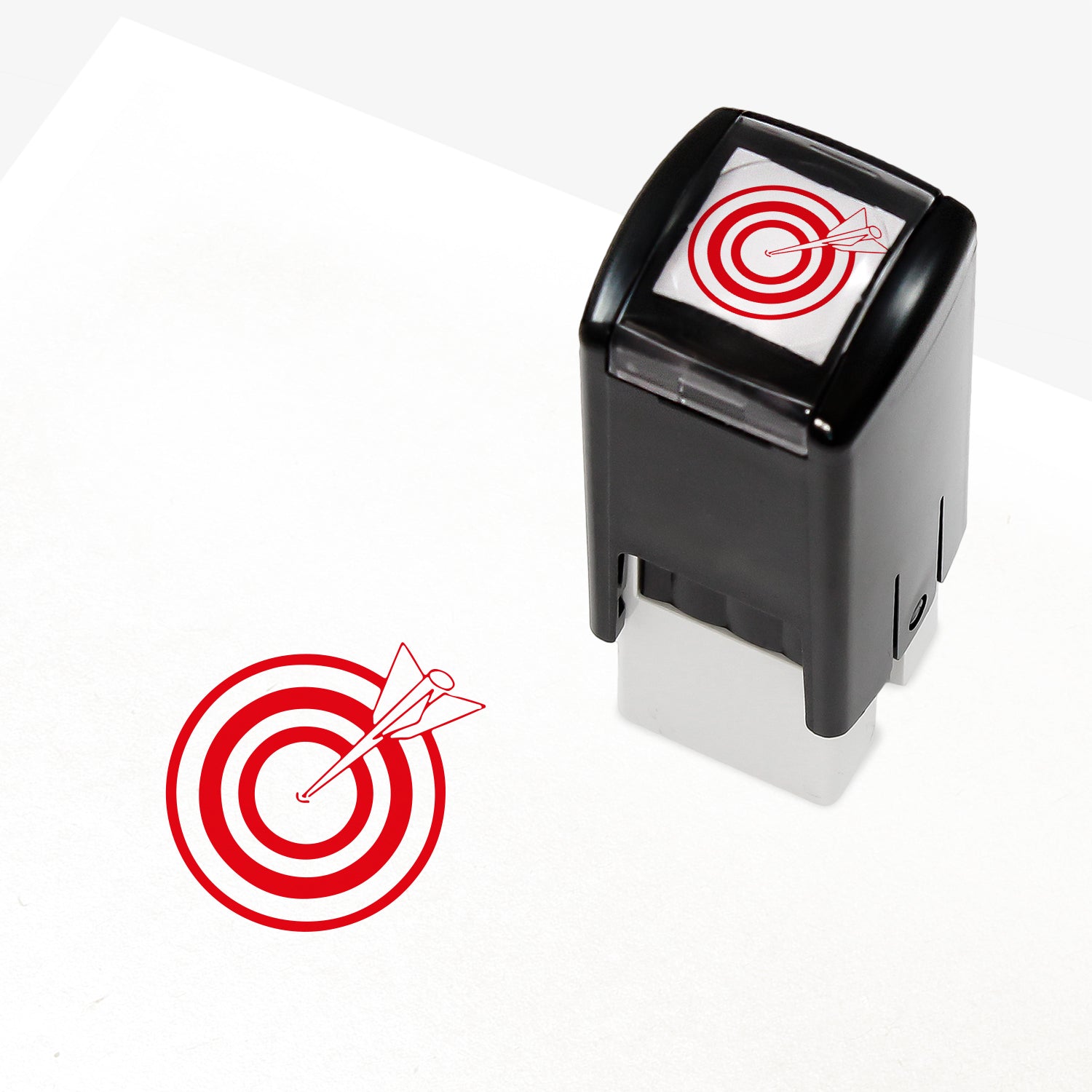 Target Stamper featuring a compact black casing with a red bullseye and arrow design. The stamp imprint measures 10mm in diameter and is available in various ink colours, ideal for marking pupil achievements.
