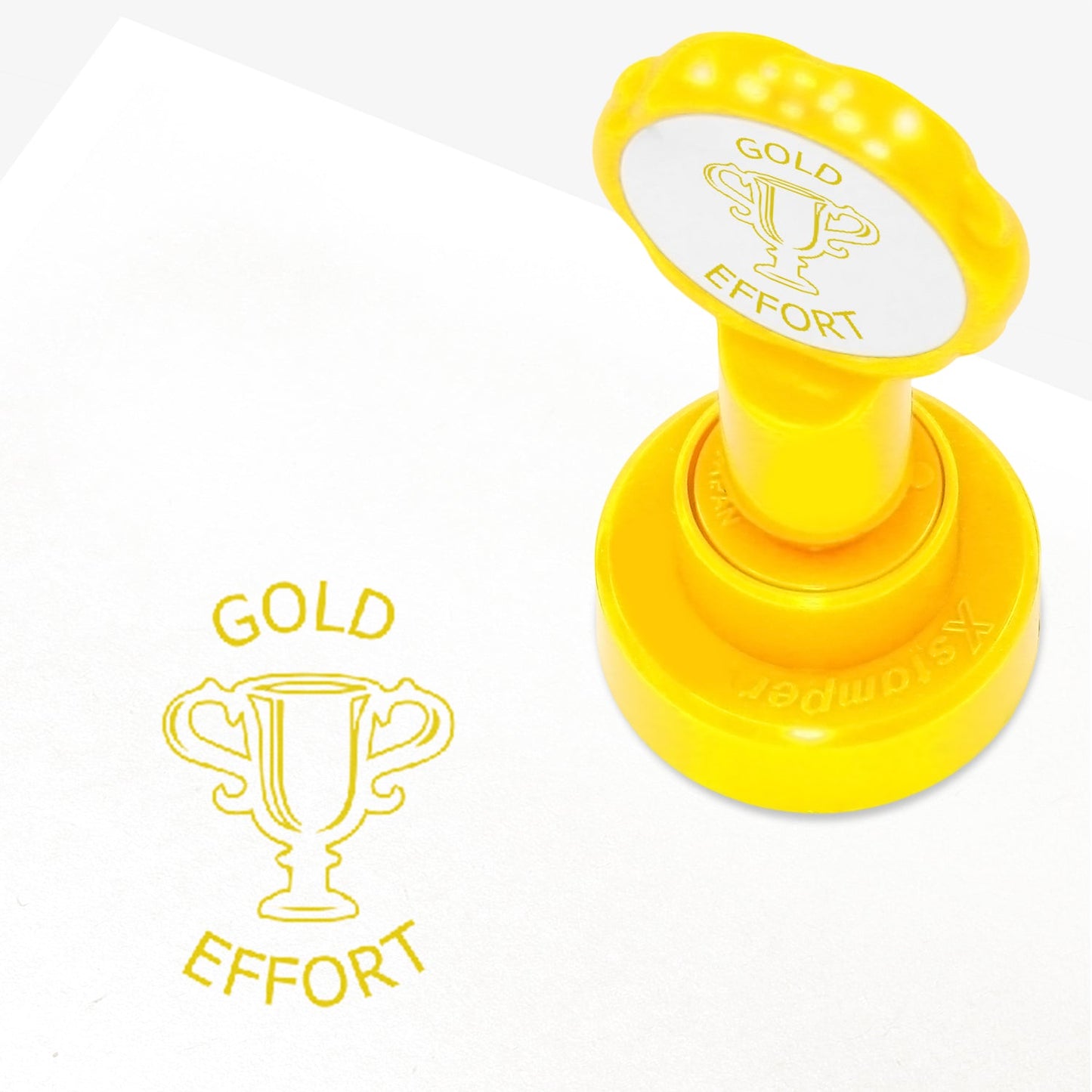 25mm self-inking stamper with gold ink.  The stamp impression is a central image of a gold trophy with the work 'GOLD' above and 'EFFORT' below.