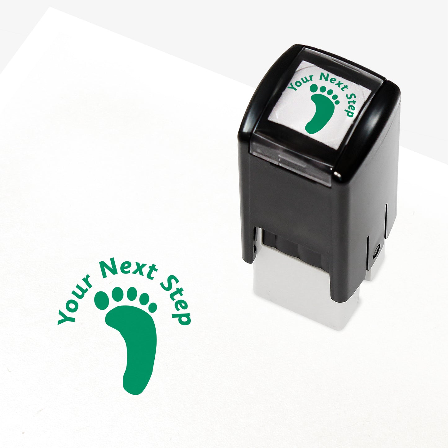 Green 25mm pre-inked stamper featuring a footprint with the phrase 'Your Next Step' above.
