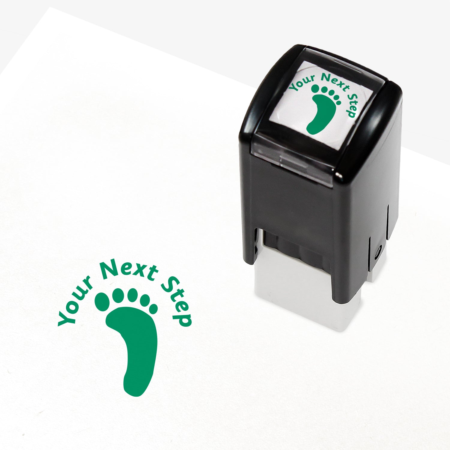 Green 25mm pre-inked stamper featuring a footprint with the phrase 'Your Next Step' above.