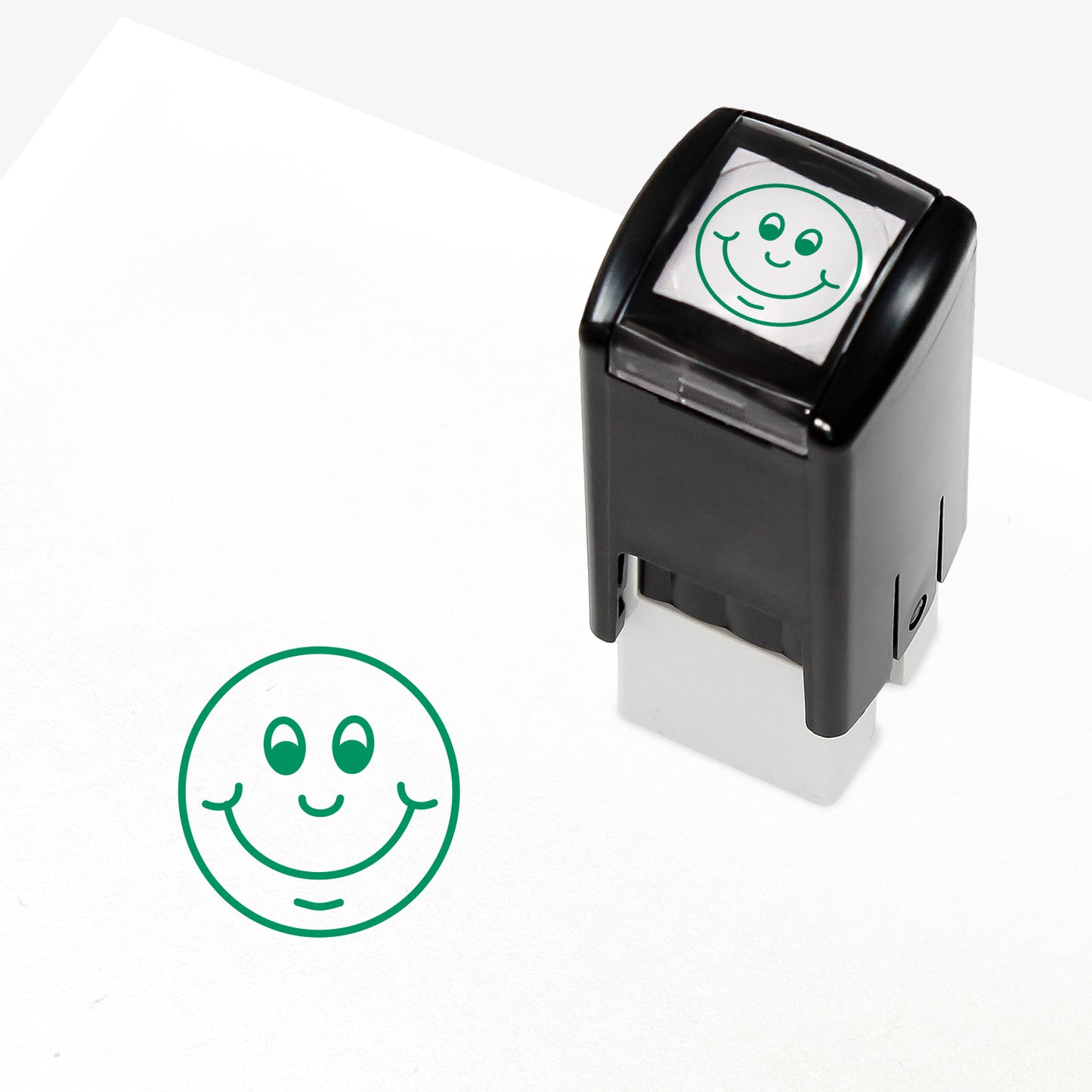 Green 10mm pre-inked stamper featuring a smiling cartoon emoji face