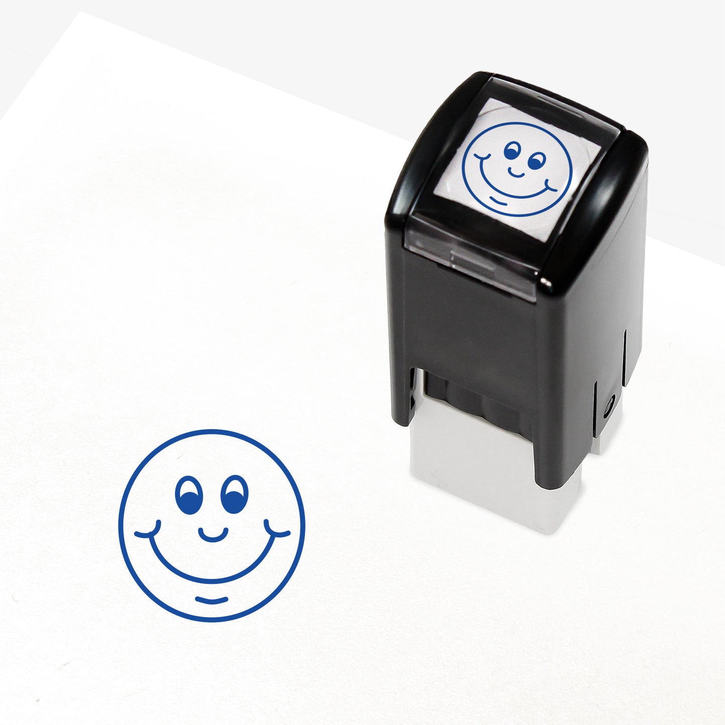 Blue 10mm pre-inked stamper featuring a smiling cartoon emoji face