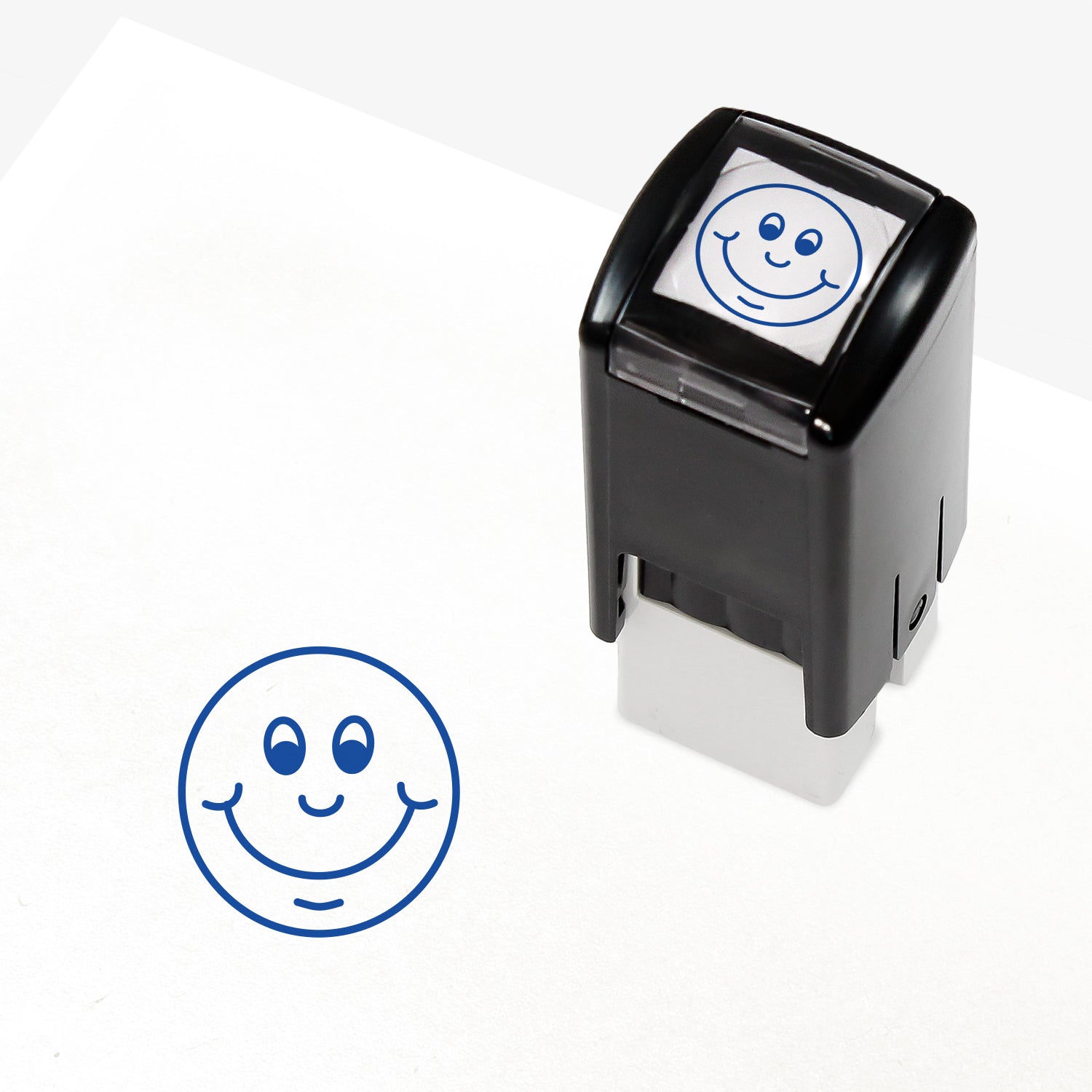 Blue 10mm pre-inked stamper featuring a smiling cartoon emoji face