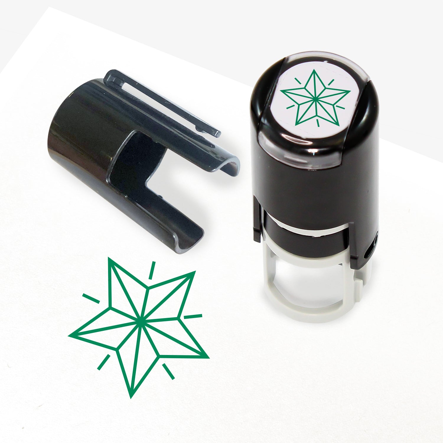 A 10mm self-inking stamp with a green outline 3D style star central to the design.  The stamper lid also shows a clip for attaching the stamper to a lanyard.