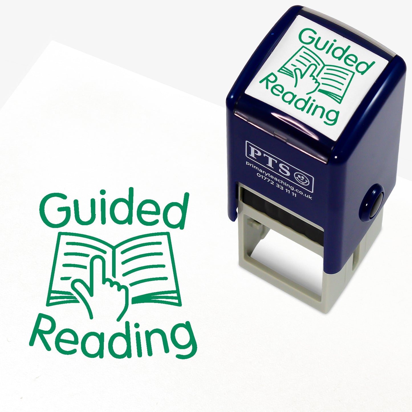 A 25mm round pre-inked teacher stamper with green ink, featuring an illustration a finger following text on an open booke, around which is the phrase 'Guided Reading'.