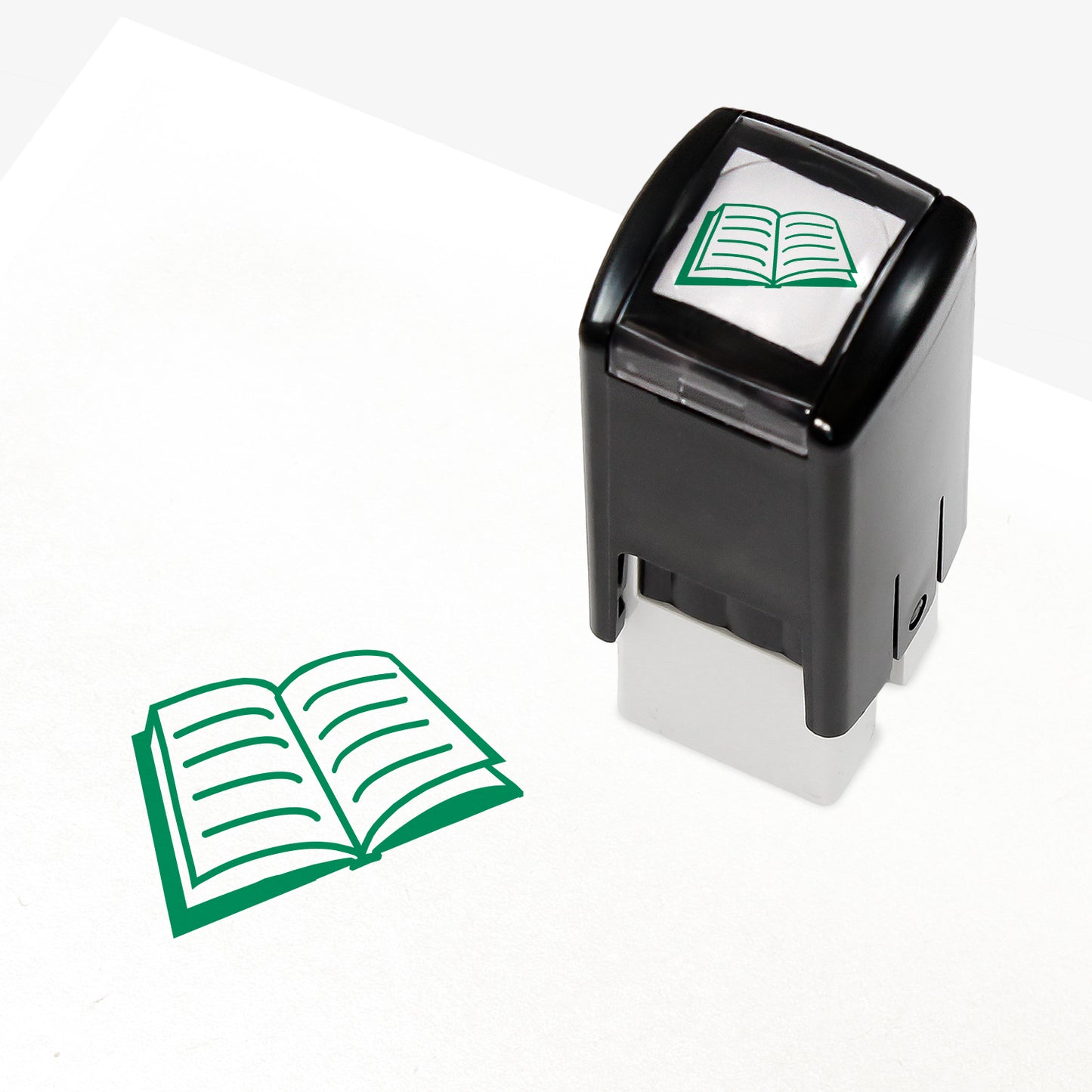 A 10mm self-inking stamp with a green open book with lined pages central to the design