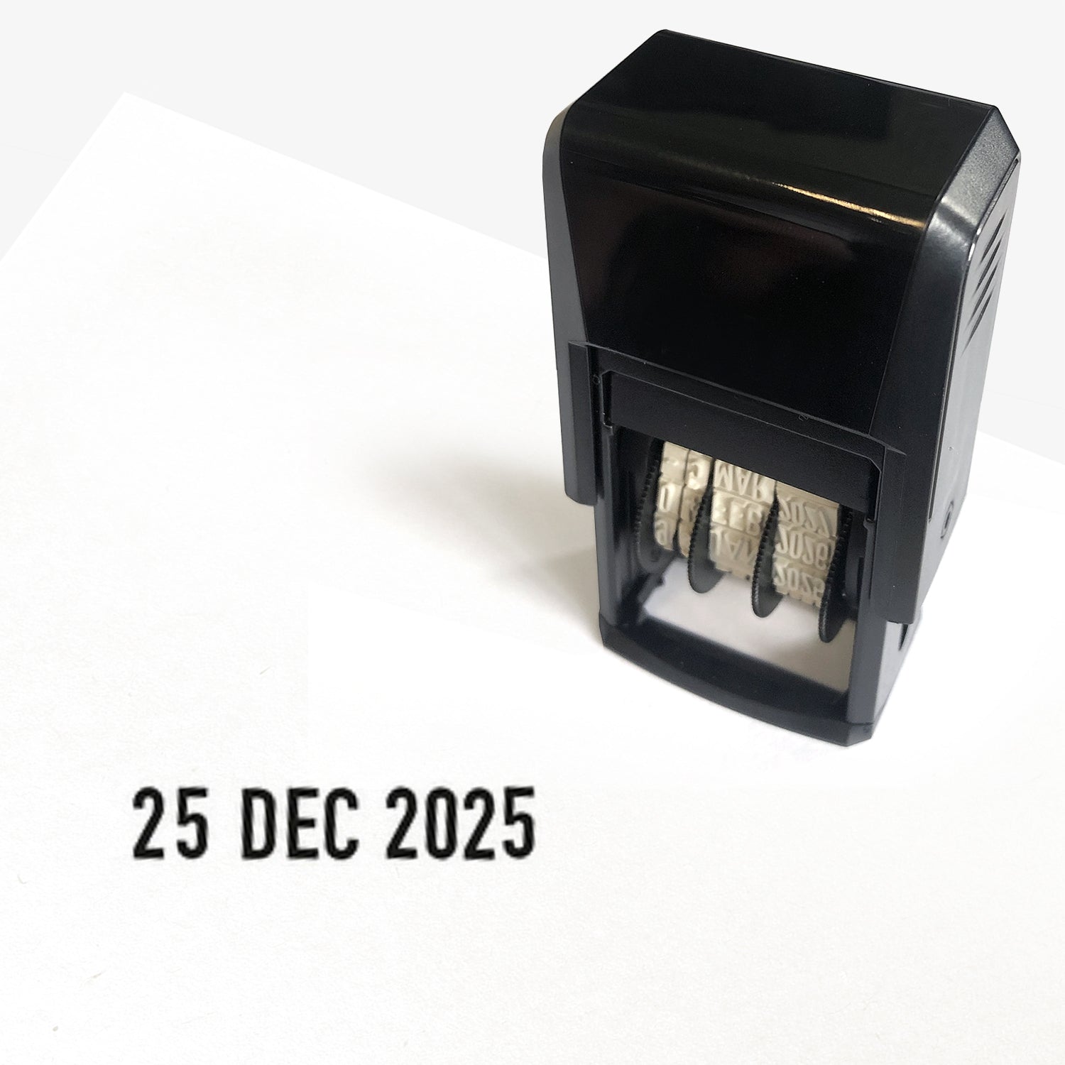 Black changeable date stamper showing the imprint '25 DEC 2025'
