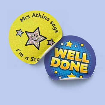Image of two stickers one blue with well done the other holographic personalised one on blue background