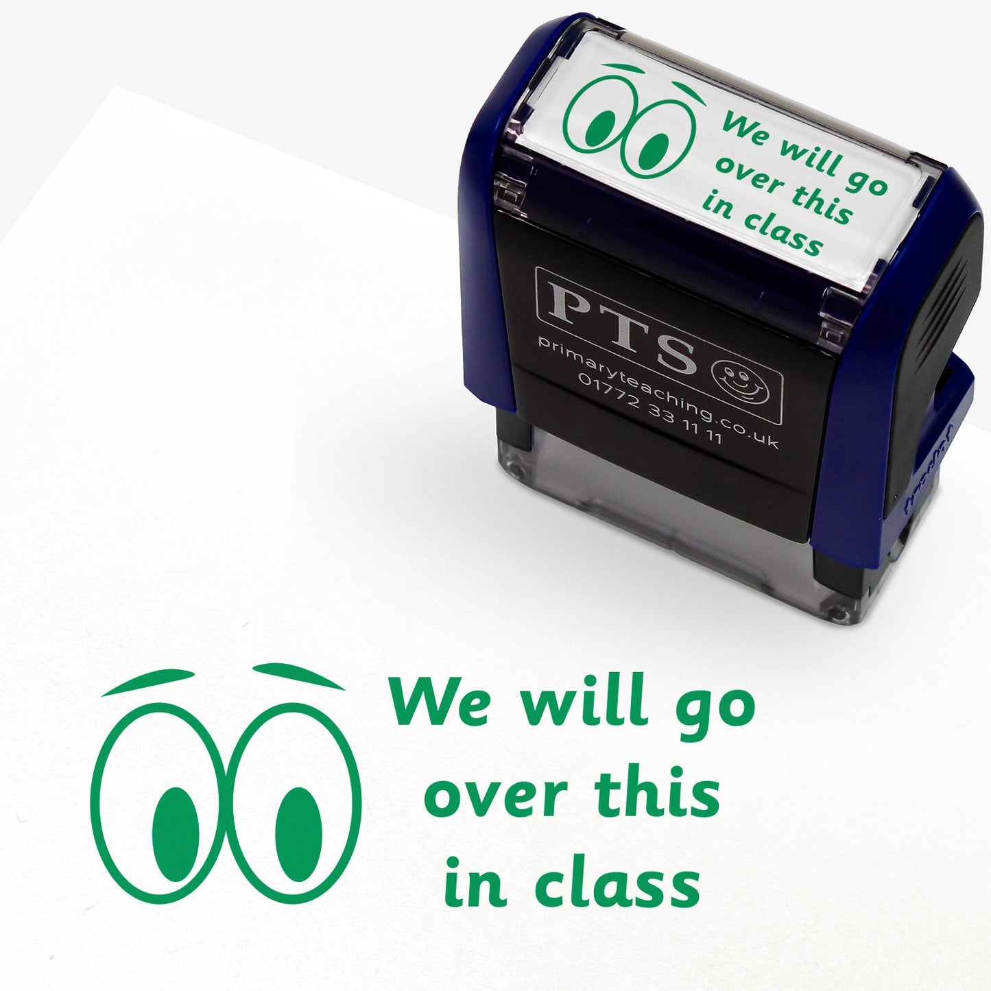 A rectangular pre-inked teacher stamper measuring 38mm x 15mm, featuring a green ink impression of two cartoon eyes beside the phrase "We will go over this in class" in a playful, rounded font. The stamper has a dark blue casing with the PTS logo and contact details on the front, designed for marking pupils' work to indicate topics to be revisited during class discussions.