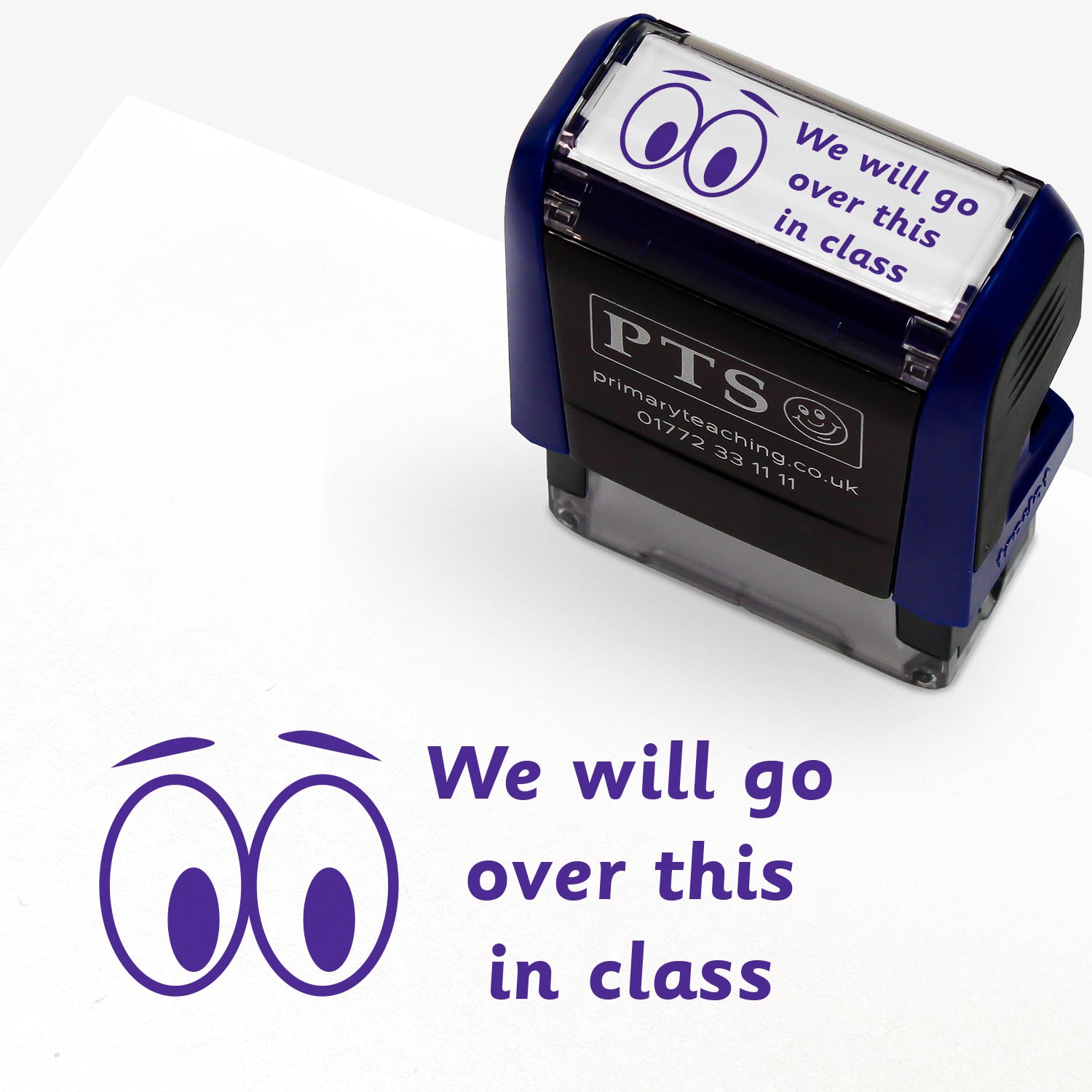 A rectangular pre-inked teacher stamper measuring 38mm x 15mm, featuring a purple ink impression of two cartoon eyes beside the phrase "We will go over this in class" in a playful, rounded font. The stamper has a dark blue casing with the PTS logo and contact details on the front, designed for marking pupils' work to indicate topics to be revisited during class discussions.