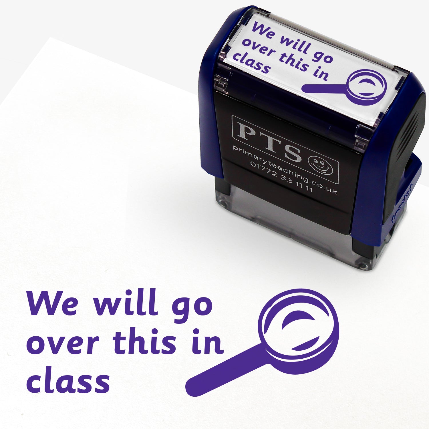 Rectangular self-inking stamper 38mm x 15mm with purple ink, displaying the text 'We will go over this in class' alongside the outline of a magnifying glass.