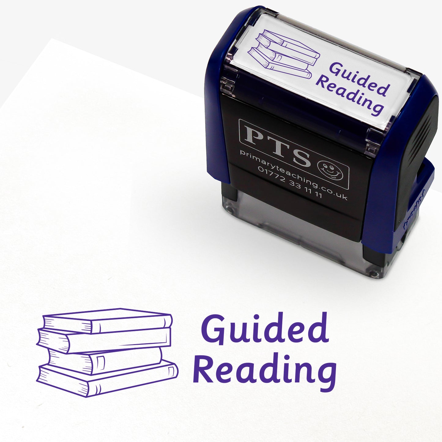 Rectangular self-inking stamper measuring 38mm by 15mm, featuring the phrase 'Guided Reading' in purple text alongside an illustration of a stack of three books; designed for marking pupils' reading records and homework diaries.