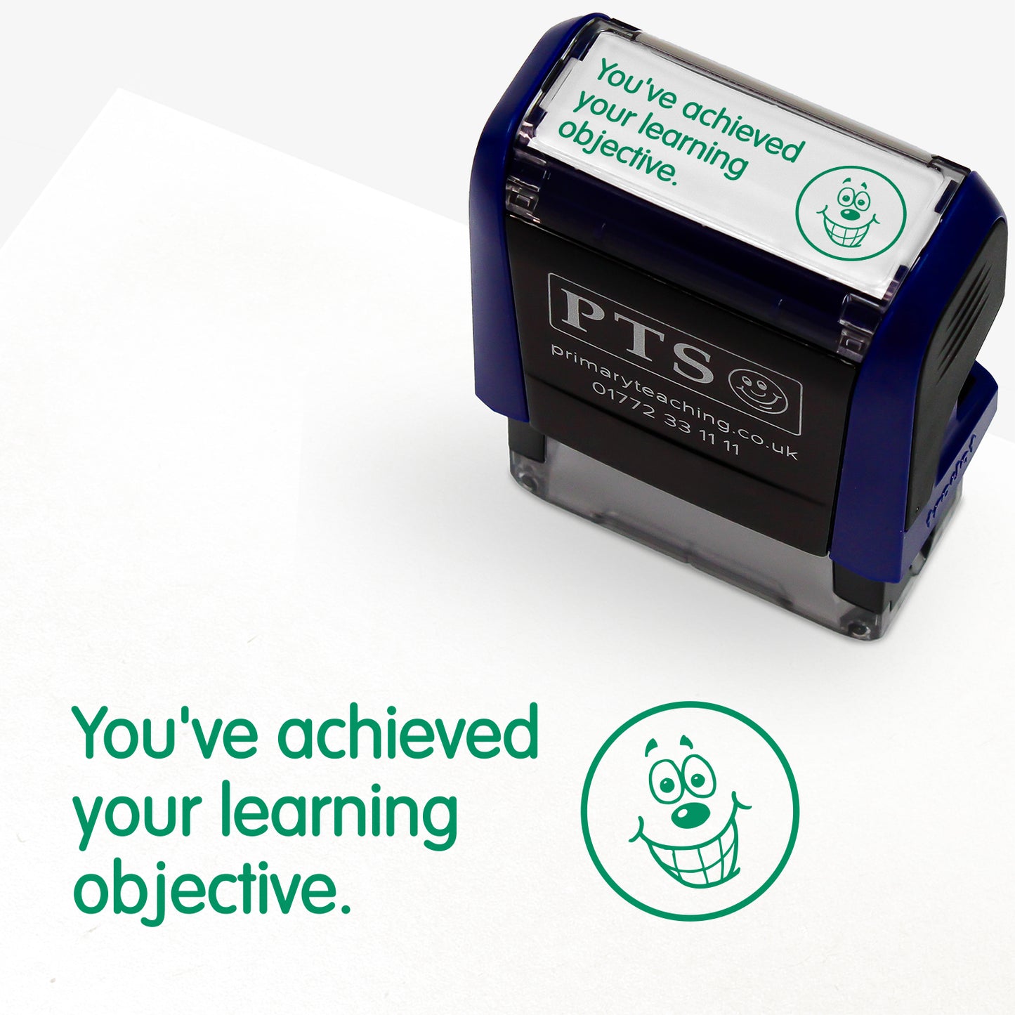 A rectangular self-inking stamper, displaying the green text 'You've achieved your learning objective' alongside a smiling emoji face; stamper measures 38mm by 15mm