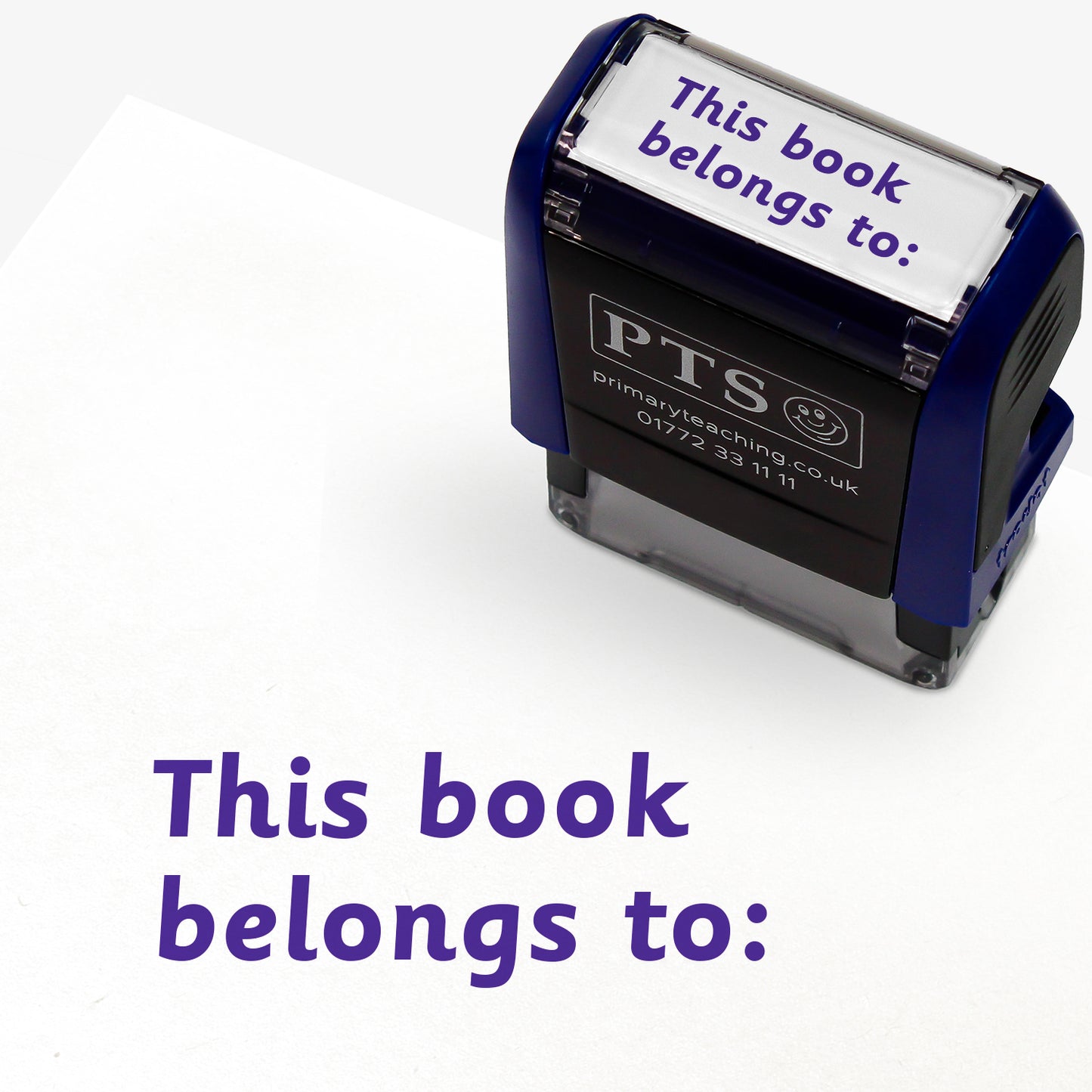 Rectangular self-inking stamper with purple ink measuring 38mm by 15mm, featuring the phrase 'This book belongs to:' across two lines.