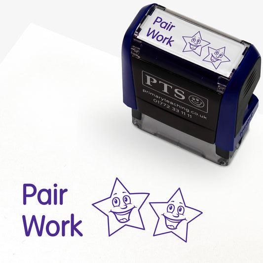 Rectangular self-inking stamper measuring 38mm by 15mm, featuring the phrase 'Pair Work' and 2 smiling stars in purple ink.