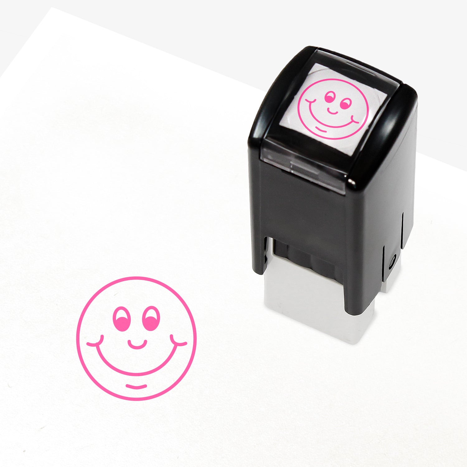 Pink 10mm pre-inked stamper featuring a smiling cartoon emoji face