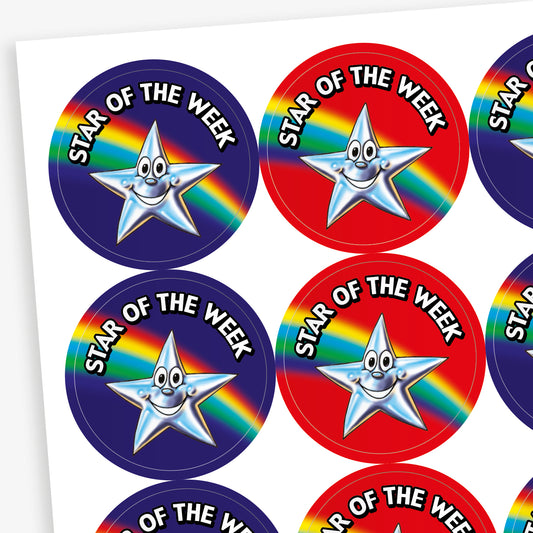 Sheet of round 'Star of the Week' stickers in red and blue, each featuring a smiling silver star character and a rainbow stripe across the background.