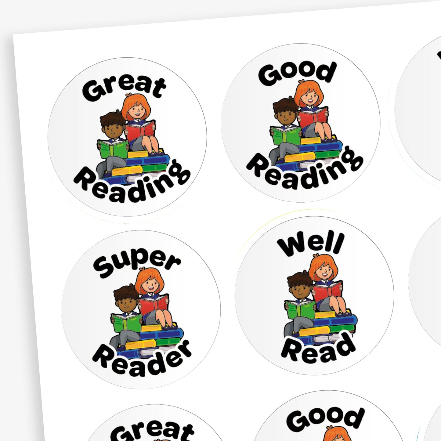 A sheet of round reading reward stickers. Each sticker features an illustration of two children—one with dark skin and short hair, the other with light skin and red hair—sitting on a stack of colourful books and reading. The stickers have various positive phrases in bold black letters such as 'Great Reading', 'Good Reading', 'Super Reader', and 'Well Read'.