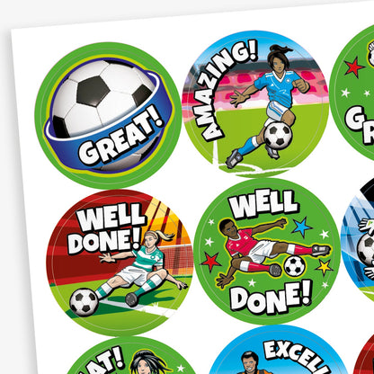 Close up of 32mm circular stickers featuring graphics of female and male footballers including kicking a fooball to score a goal and a goalkeeper saving a goal, alongside central football images.  Phrases include 'WELL DONE', 'GREAT' and 'AMAZING'
