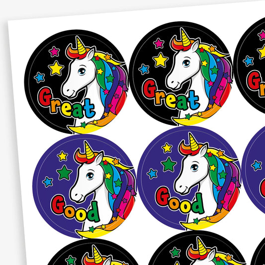 Sheet of 20 round vibrant-coloured stickers, each 32mm in diameter, featuring a white unicorn with a rainbow mane and horn, surrounded by stars. Each sticker displays one of five motivational words: 'Great', 'Magic', 'Super', 'Wow!', or 'Good'.