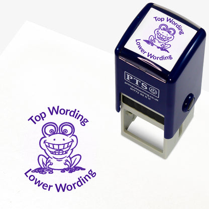 A 25mm round pre-inked teacher stamper with purple ink, featuring an smiling frog, curving above the image is space for personalisation 'Top Wording' and curving below the image is space for personalisation 'Lower Wording' in a clear, bold font.
