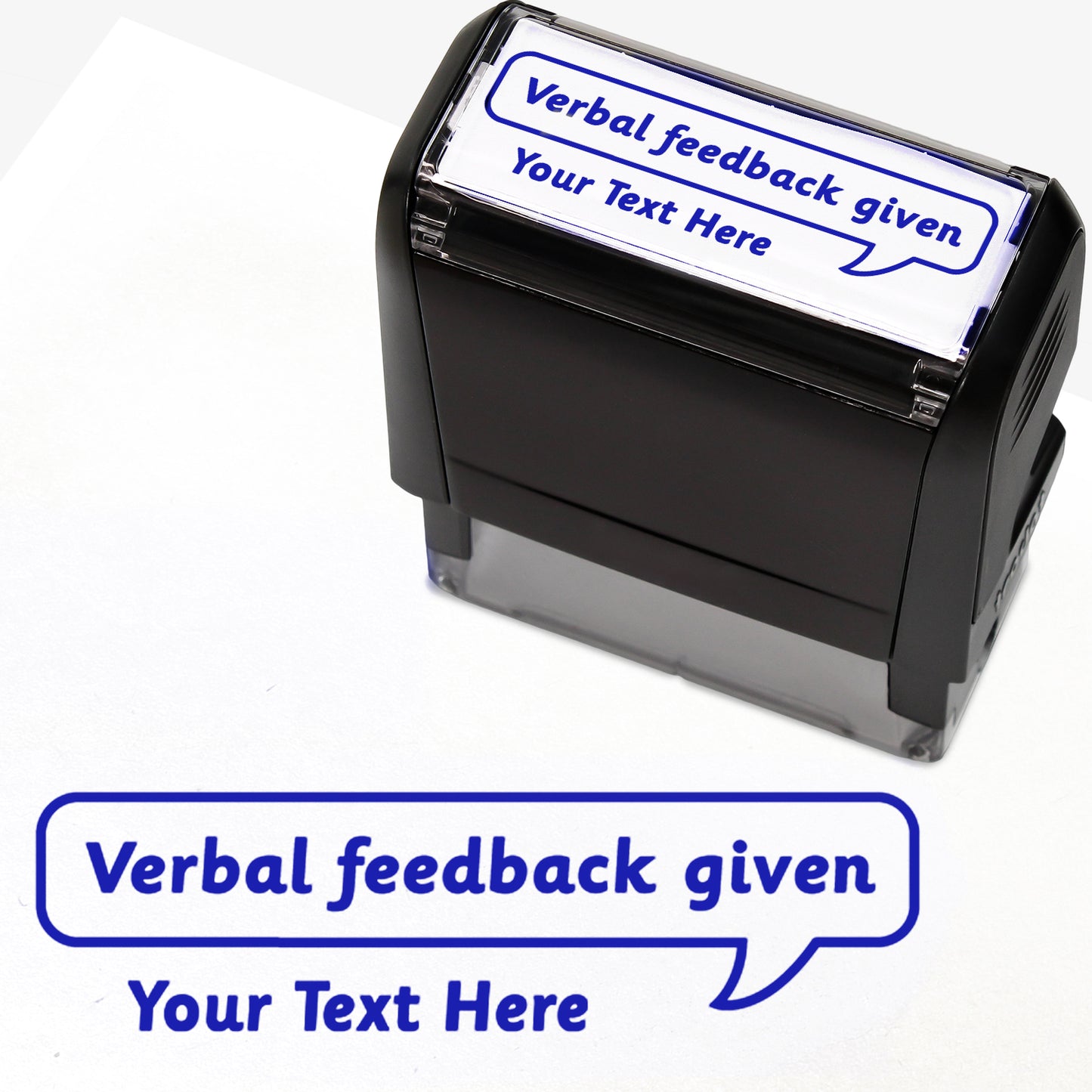 Rectangular self-inking stamper measuring 59mm by 21mm, featuring the phrase 'Your Text Here' leading onto a speech bubble going above it also saying 'Verbal Feedback Given'. In blue ink.