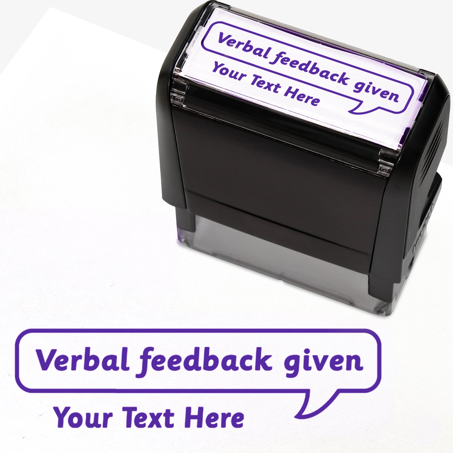 Rectangular self-inking stamper measuring 59mm by 21mm, featuring the phrase 'Your Text Here' leading onto a speech bubble going above it also saying 'Verbal Feedback Given'. In purple ink.